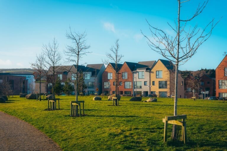 Modern brick terraced townhouses facing a green on a UK residential development
