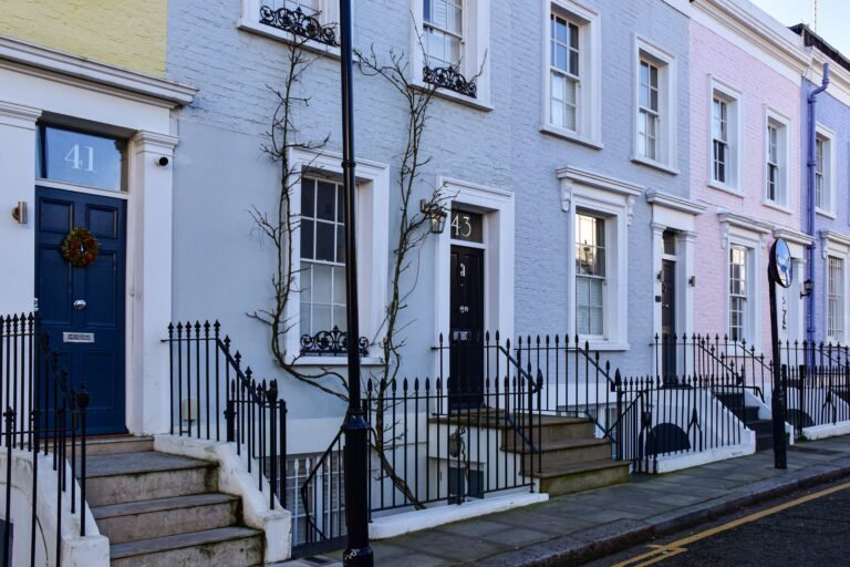 Row of pastel-painted terraced townhouses